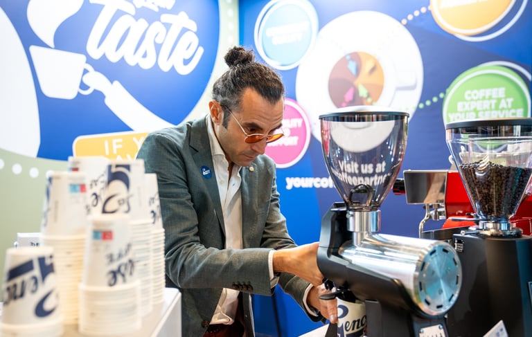 Matteo grinding coffee during Host Milan 2023