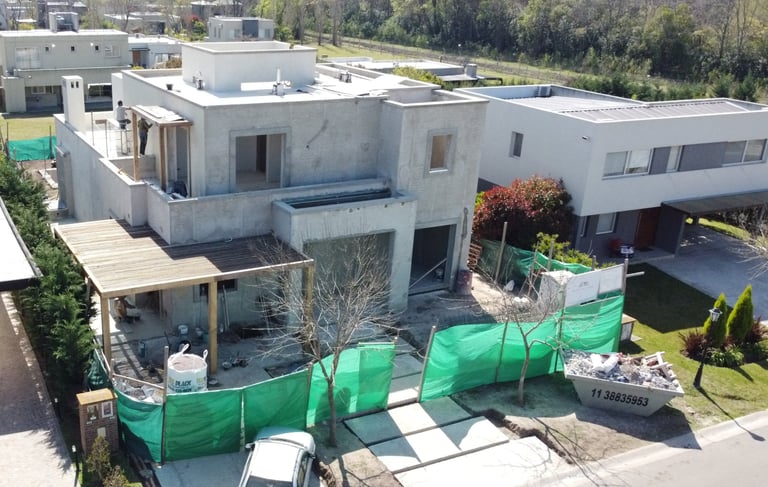 a house with a green tarp and a car parked in front of it
