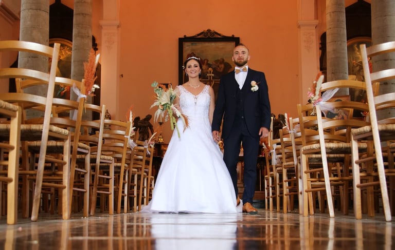 a bride and groom walking down the aisle of a church