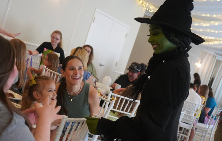Elphaba talking with guests during a dining experience