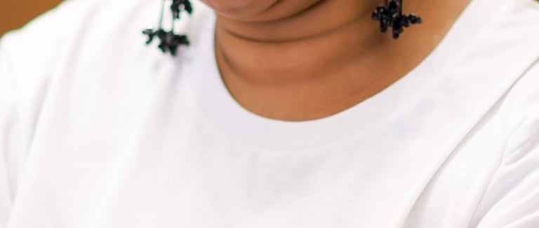 a woman sitting at a table with a microphone and a microphone