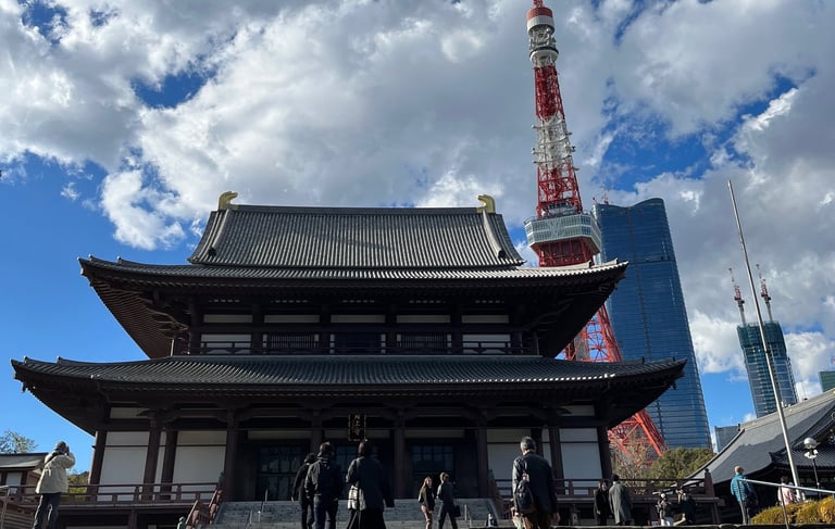 a large building with stairs and a tower in the background