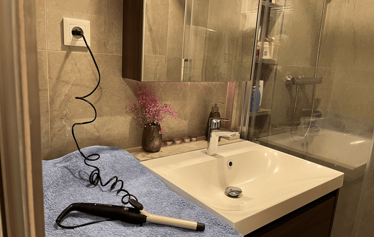 a hair dryer sitting on a towel in a bathroom