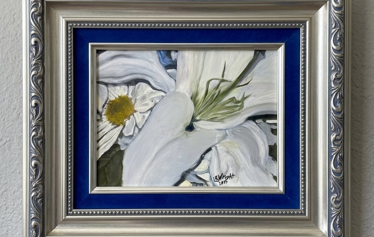 Framed oil painting of white lilies and a daisy in an ornate silver frame with blue velvet matting.