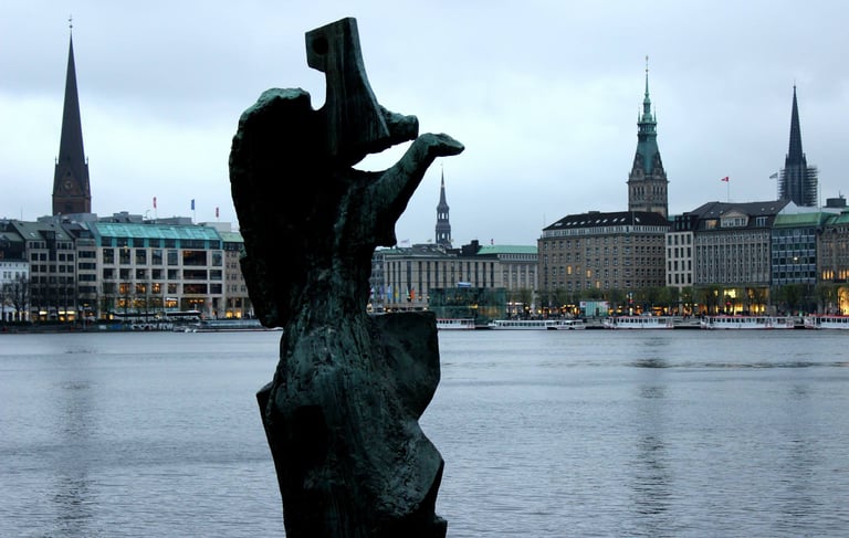 a statue of a figure overlooking a body of water