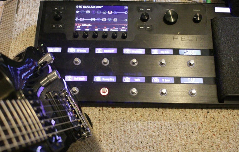A Line 6 Helix multi-effects guitar processor pedalboard, electric guitar, inquire for lessons.