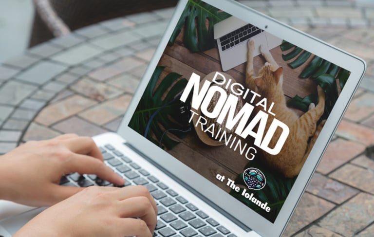 The Iolande Digital Nomad Training Program on a laptop at s café.