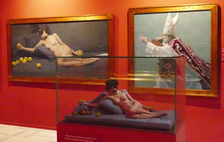 Contemporary art exhibition featuring a nude sculpture in a glass case beside classical oil paintings.