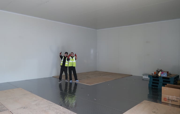 Happy colleagues in a giant freezer room in London