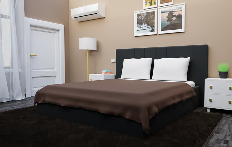 a bed room with a bed and a lamp