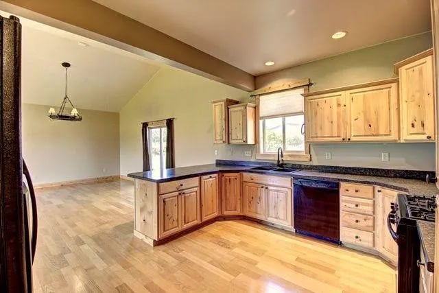 Custom wood floors and trim with black grnaite counter tops in this custom luxury home