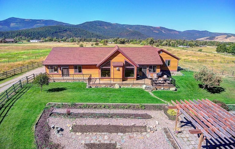 26205 sliding Horse Ln - Aerial House with Montana mountains -Saddle Horn Custom Homes