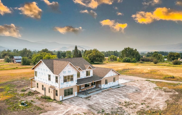 a large house being built with a Montana valley in the background