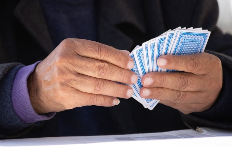 Person holding playing cards