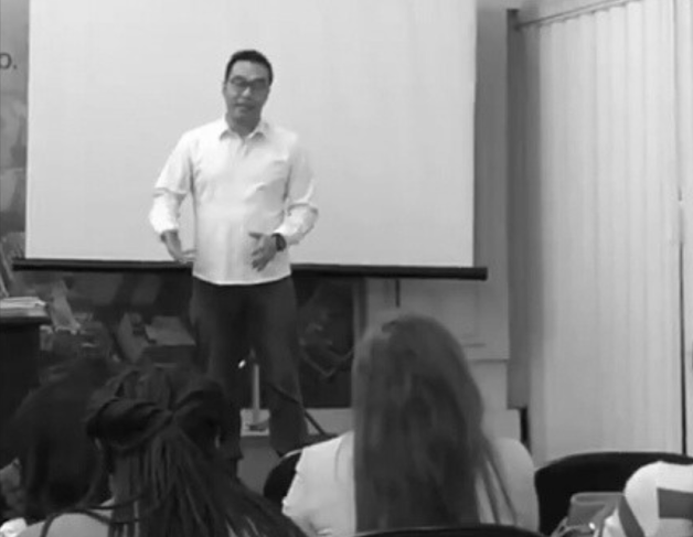 a man standing in front of a presentation on a presentation