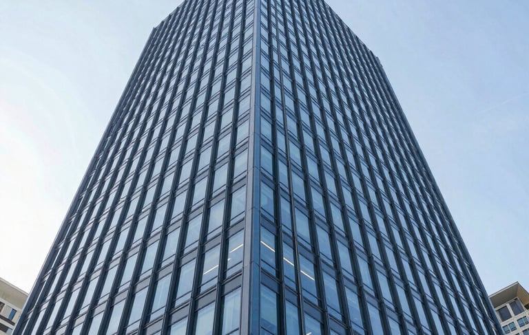 A low-angle, architectural photograph of a contemporary commercial real estate skyscraper in a North American business district. The building features clean glass lines and steel blue frames. The lighting is bright, clear daylight, reflecting a sophisticated and trustworthy corporate environment. Professional and sharp composition.