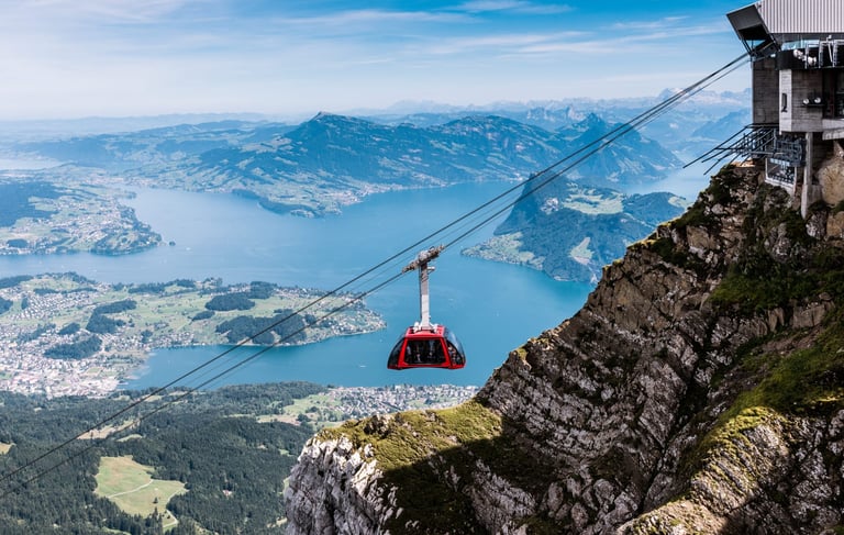A cable car suspended from a cable, offering scenic views of the surrounding landscape.