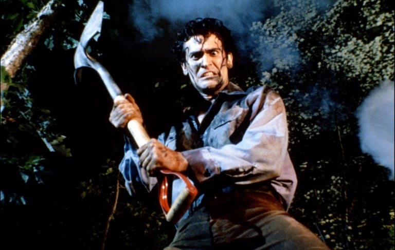 a man in a black shirt holding a hammer hammer and a large axe