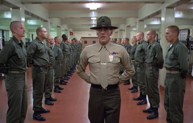 a man in uniform uniform standing in a room with other uniformed personnel