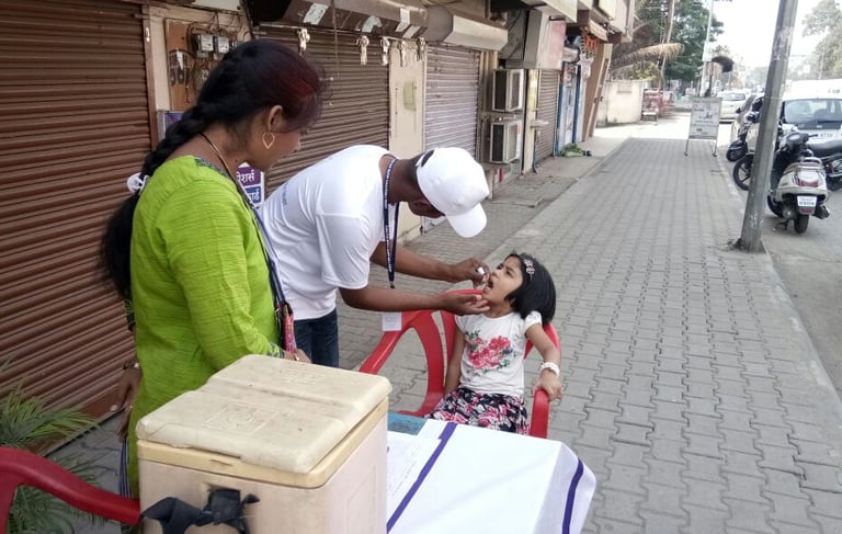 a woman and a man is giving a child vaccine