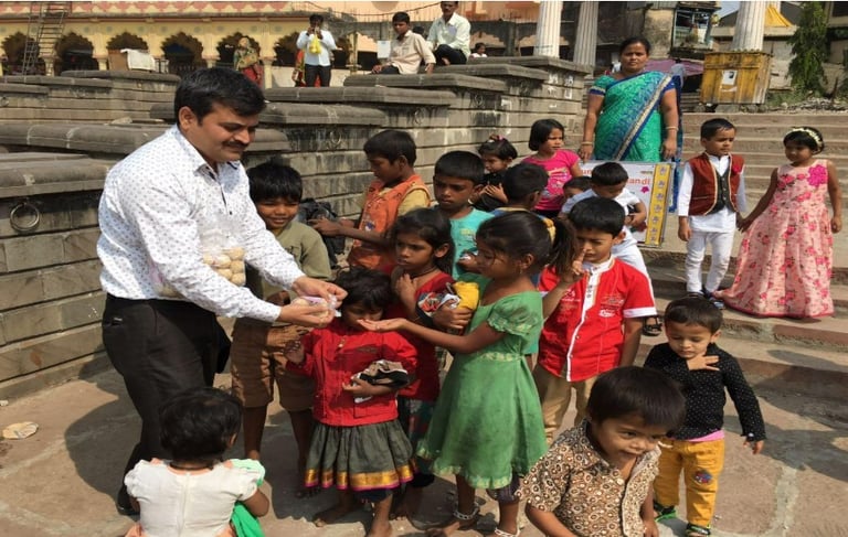 a man is giving a child a something to eat