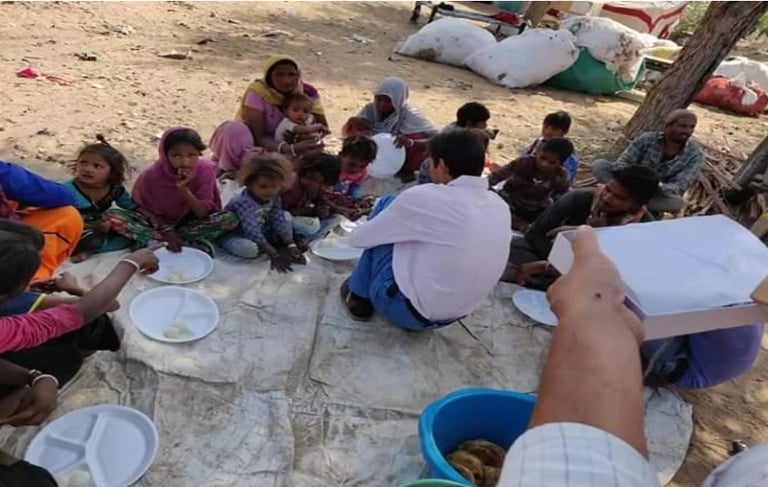 a group of people sitting around on the ground