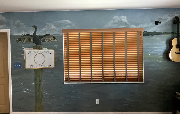 Wall mural of Ft. DeSoto, waterway sign, and cormorant in an office. 