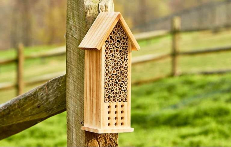 a birdhouse with a beehive and a beehive