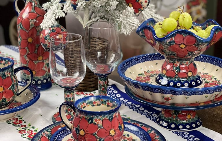 a table setting with a vase and a vase with fruit