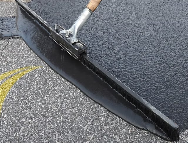 Sealing asphalt driveway to give a lasting protective layer preventing future ware