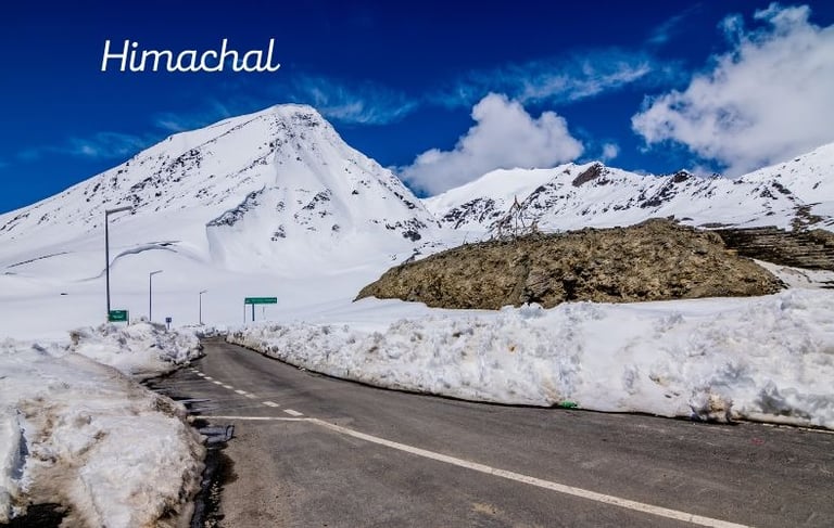 a road with snow on the side of a mountain
