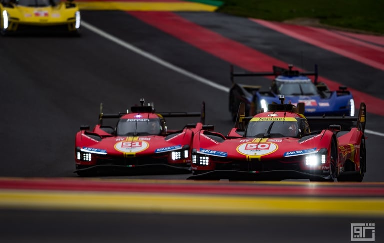 Ferrari 499P Hypercars racing on a track during an endurance motorsport event with headlights on.