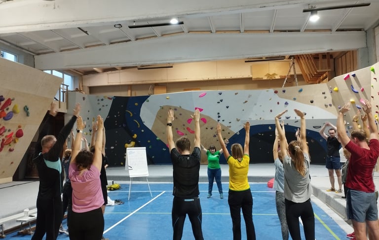 a group of people exercising in a climbing gym