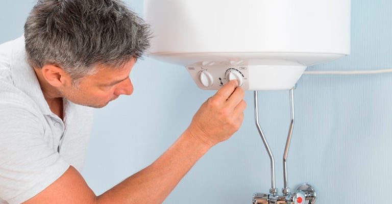 a man is looking at a water heater