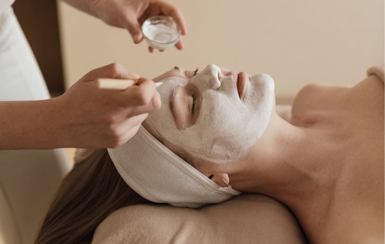 a woman getting a facial mask with a facial mask