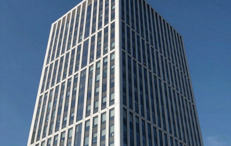 A professional architectural photograph of a sleek, modern corporate office tower in a North American / International Business hub. The image features high-contrast lighting, sharp glass reflections, and a palette of white, gray, and deep blue against a clear sky.