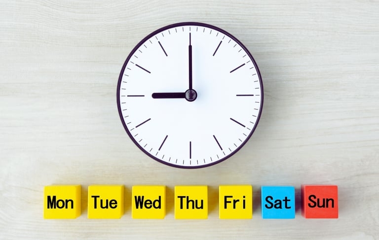 A black and white analog face with a line of 7 small cubes lined up below labeled with days of week.
