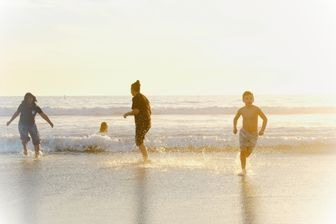 a group of people playing in the water
