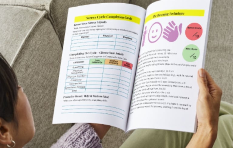 a woman is reading course resources while sitting on a couch
