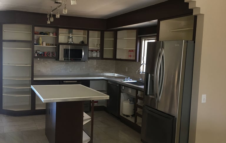a kitchen with a refrigerator and a refrigerator freezer