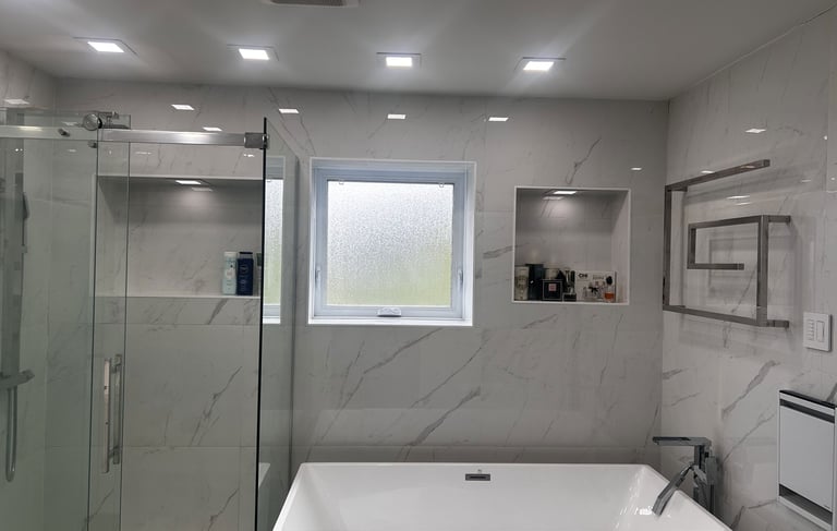 a bathroom with a tub tub and a glass shower