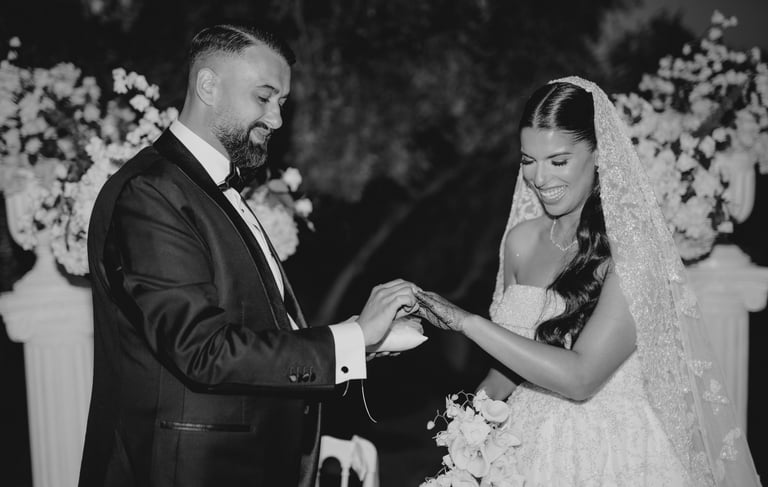 a bride and groom holding hands while they are getting married