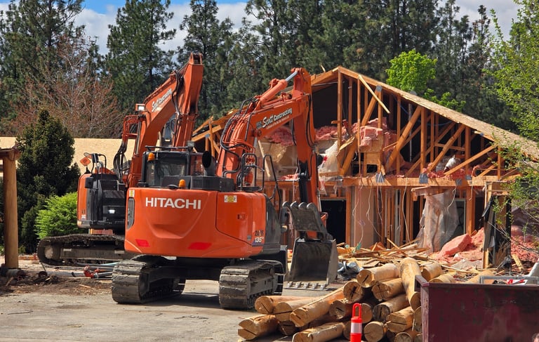 two excavators demolishing a structure