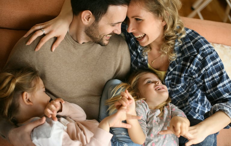 young family on the sofa laughing