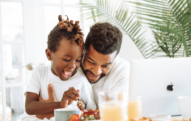 father and child eating at table