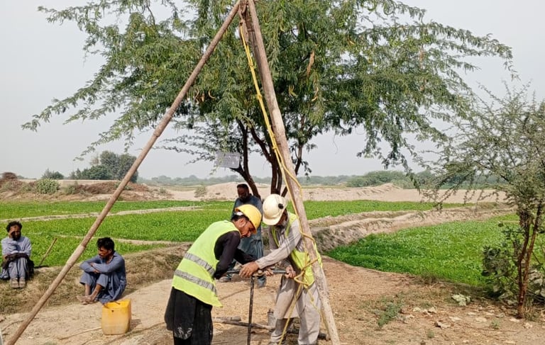 a group of people standing around a wooden structure