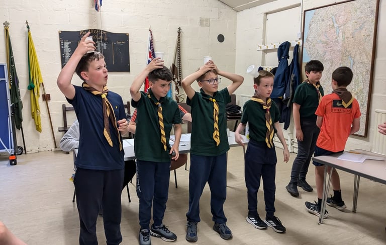 Scouts carrying out games and activities in the hut at Grassendale