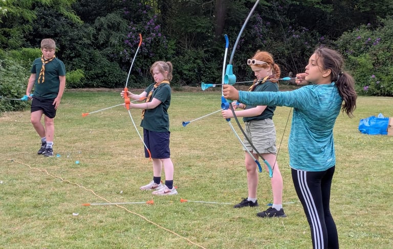 Scouts using bows while on a trip out from Allerton