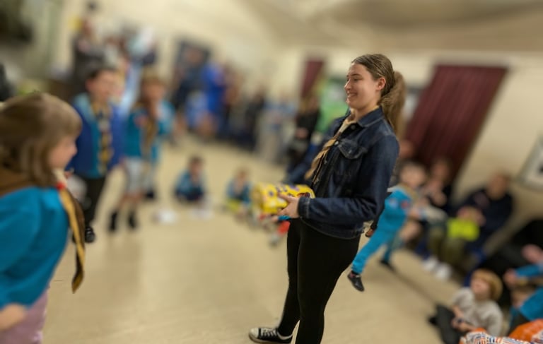 A young leader gets a present at the Scout hut in Cressington
