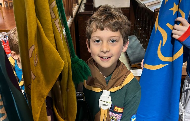 A happy cub waiting to carry a flag in St Mary's Church Allerton